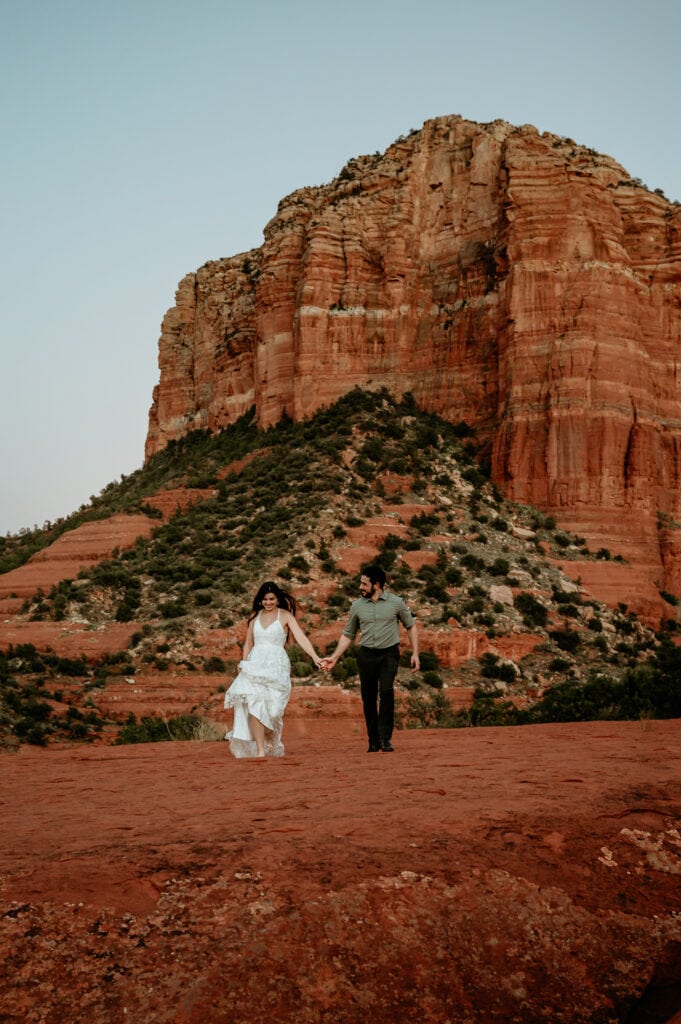 Couple running after the sun goes down during their Sedona wedding