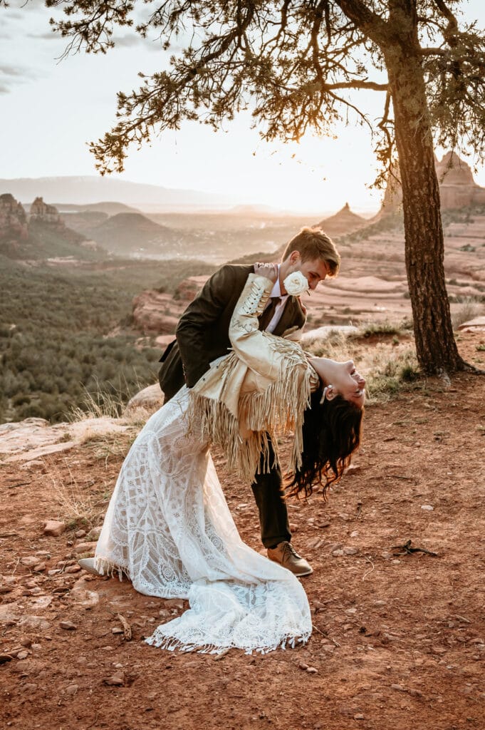 Couple dancing during their Sedona elopement overlooking a gorgeous pink sunset