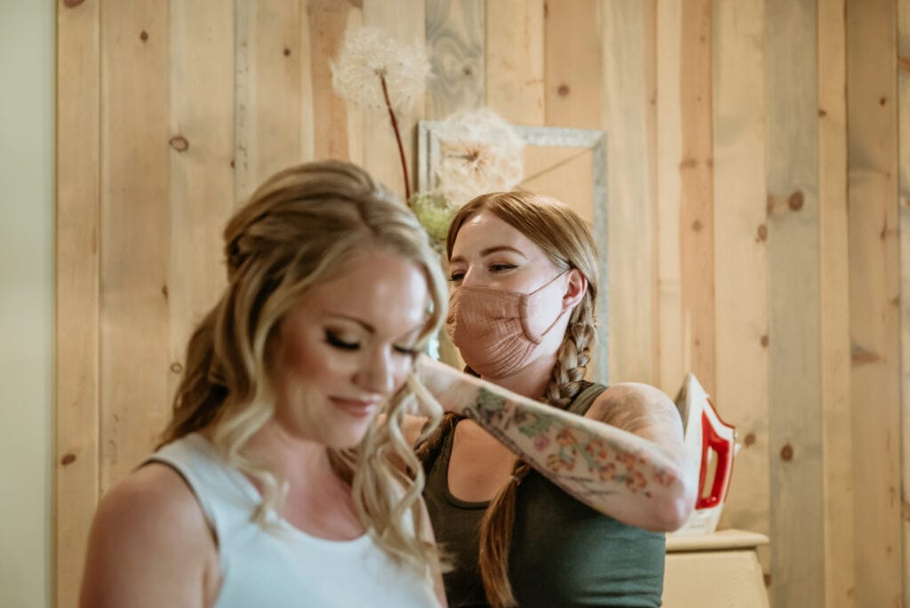 Bride having last touches of getting ready by Ash from Desert Sage Hair and Makeup