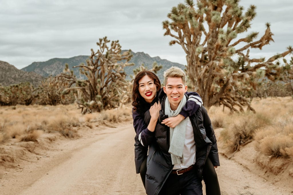 Laughing couple in Joshua Tree forest
