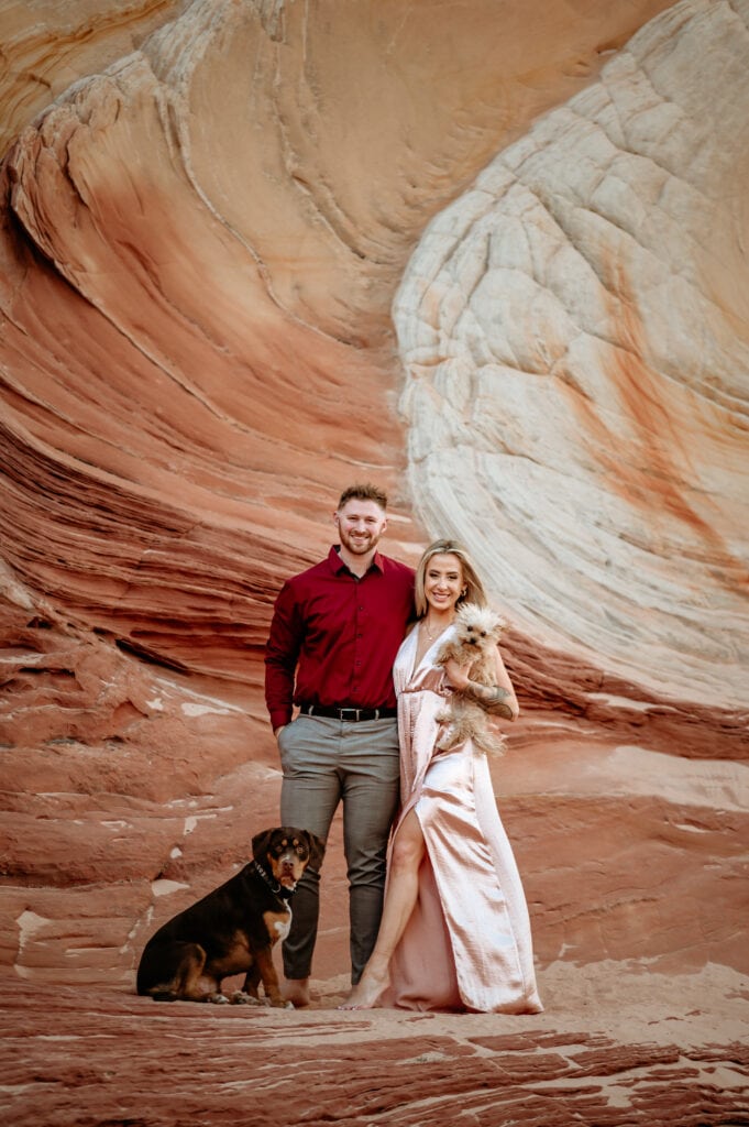 Engaged couple with their two pups during their Vermillion Cliffs engagement Session