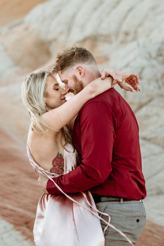 Couple embraces with their eyes closed