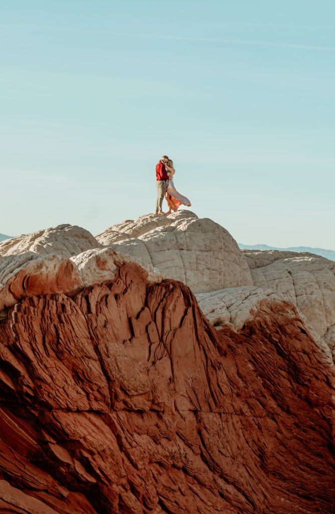 Couple standing at the top of a secret red rock formation by Arizona Elopement Photographer Shannon Durazo from Stratus Adventure Photography