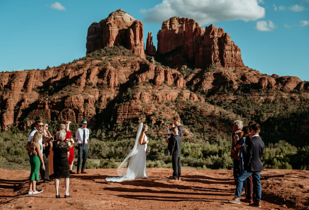 Elopement with family with views of cathedral rock towering behind the ceremony in Sedona, Arizona