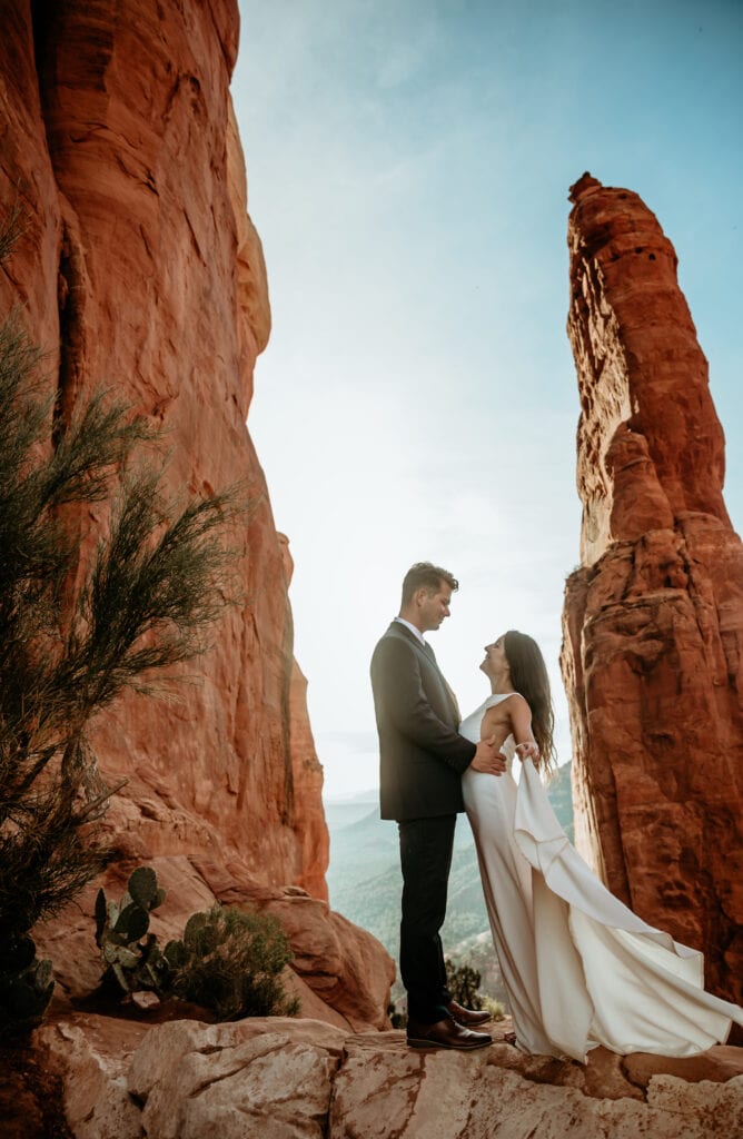 Bride and groom at sunrise by the vortex spire at Cathedral Rock