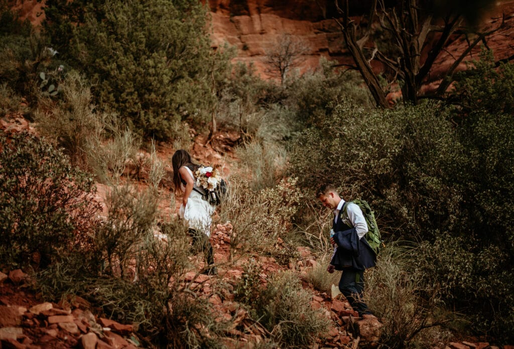 Couple hiking up a mountain for their elopement wedding in Sedona, Arizona