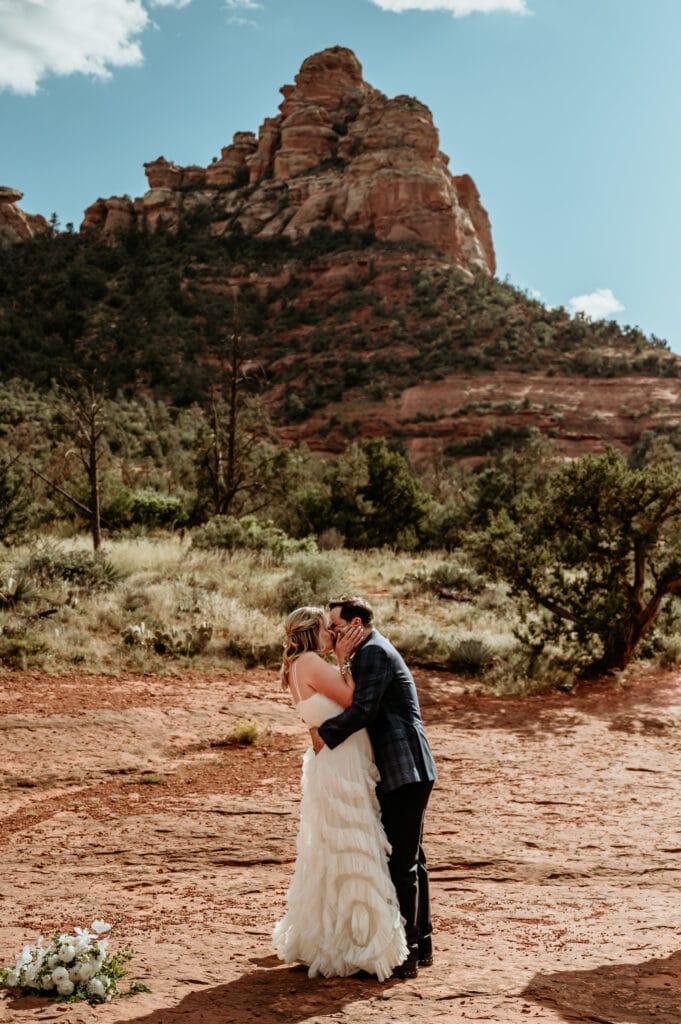 Bride and Groom have their first kiss surrounded by the Sedona red rocks