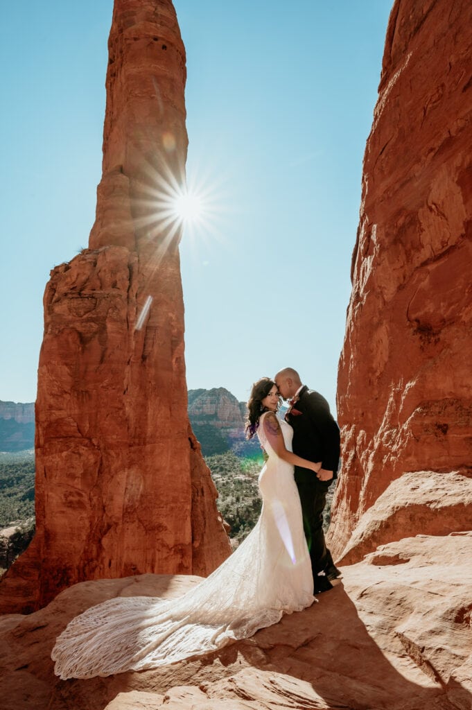 Sedona elopement couple embrace on the red rocks