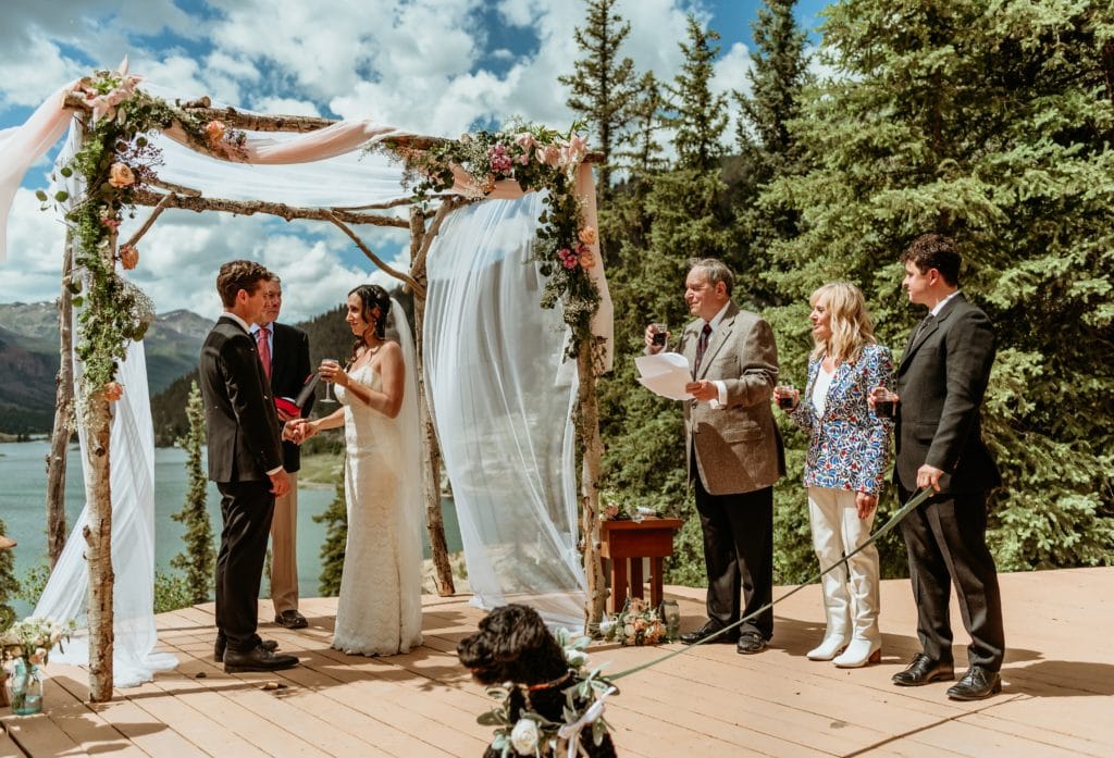 Liz and Benton during the reading of the seven blessings during their Lake San Cristobal wedding