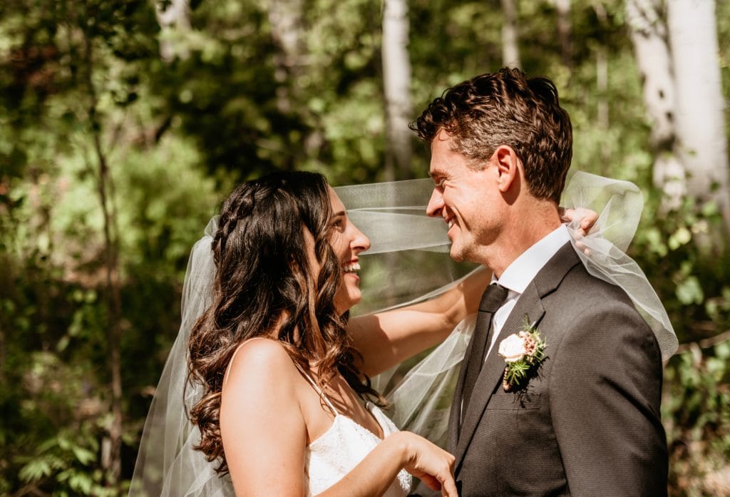 Bride and groom laughing during their Colorado mountain wedding