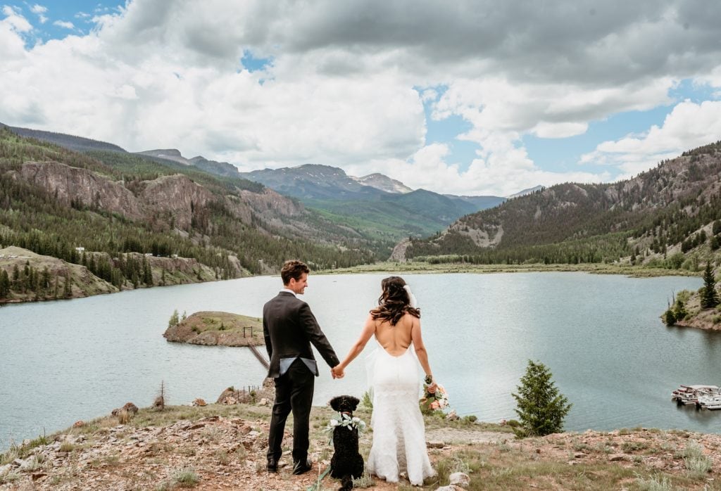 Bride, Groom, and their pup looking out over Lake San Cristobal and the San Juan Mountains on their wedding day