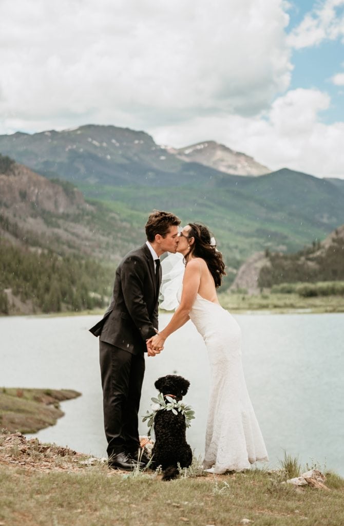 A windblown kiss overlooking Lake San Cristobal on wedding day