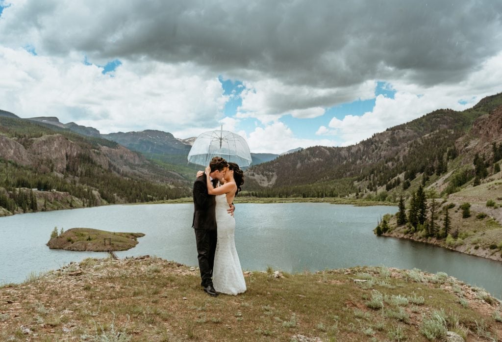 Couple embrace in a romantic kiss during their Lake San Cristobal elopement