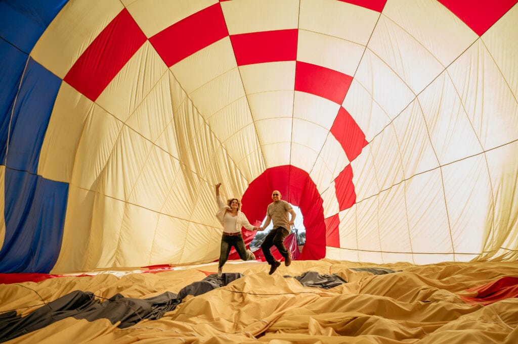 Couple jumping inside a hot air balloon in Sedona, AZ