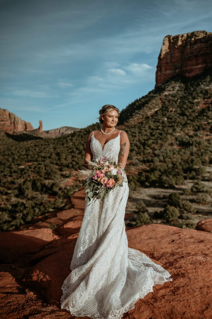 Sedona bride with vibrant bouquet of cacti and pink florals taken by Shannon Durazo, a local Sedona elopement photographer