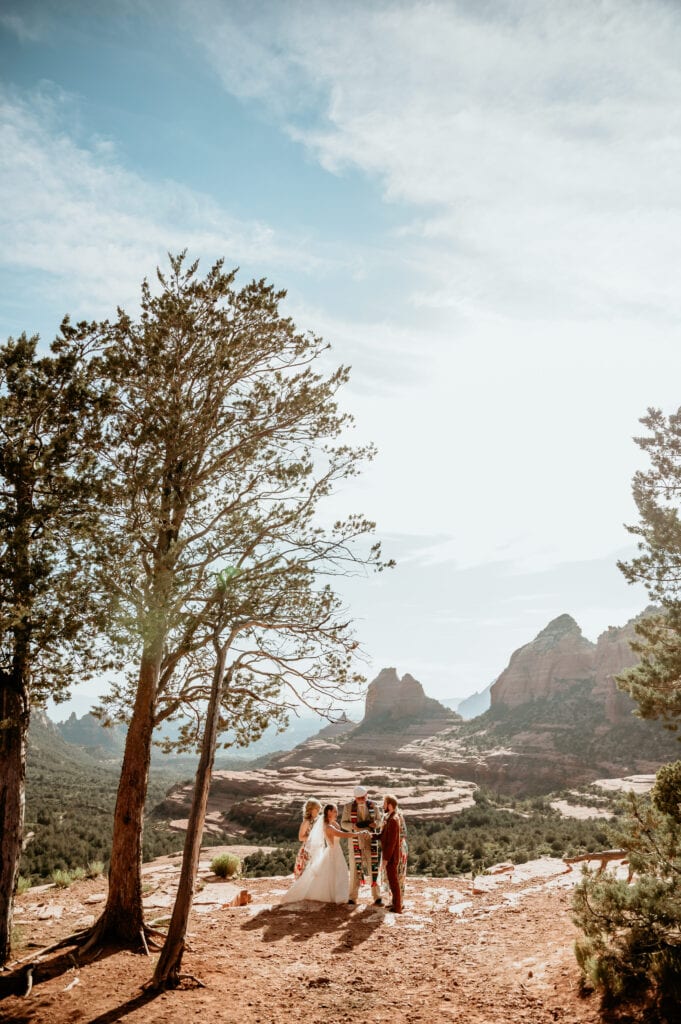 Intimate elopement ceremony on a cliff overlooking Sedona during adventurous off-road elopement