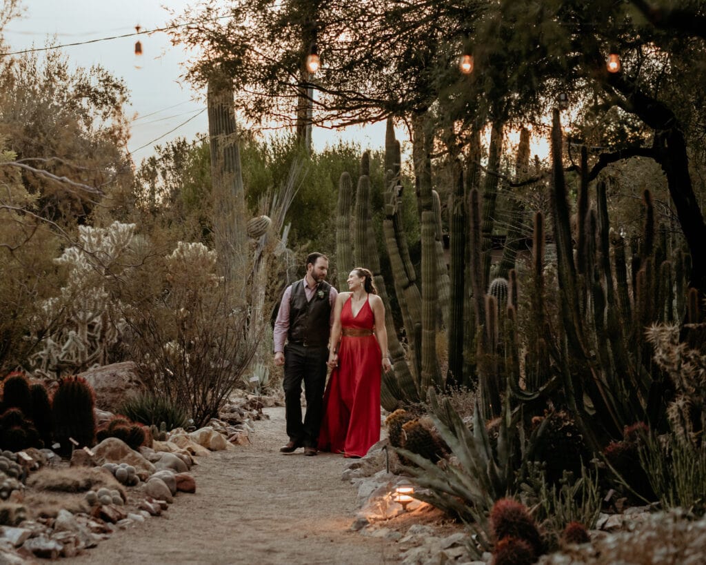 Bride and groom walking through Tucson Botanical Gardens during their elopement