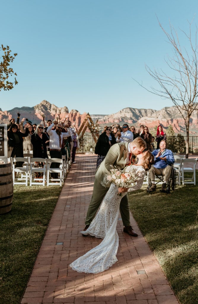 Groom dips bride on their ceremony exit during their Sedona wedding at Sky Ranch