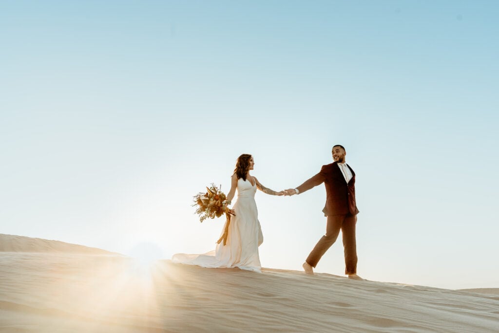 Glamis elopement couple walking hand in hand at sunset
