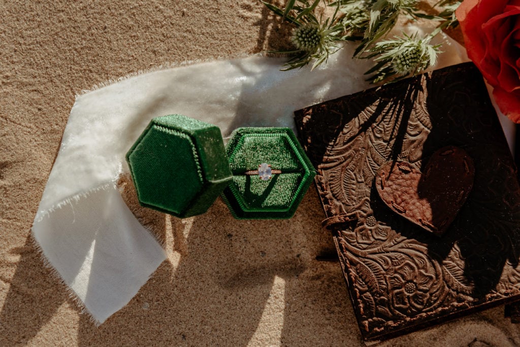 Unique wedding ring displayed in deep green velvet ring box
