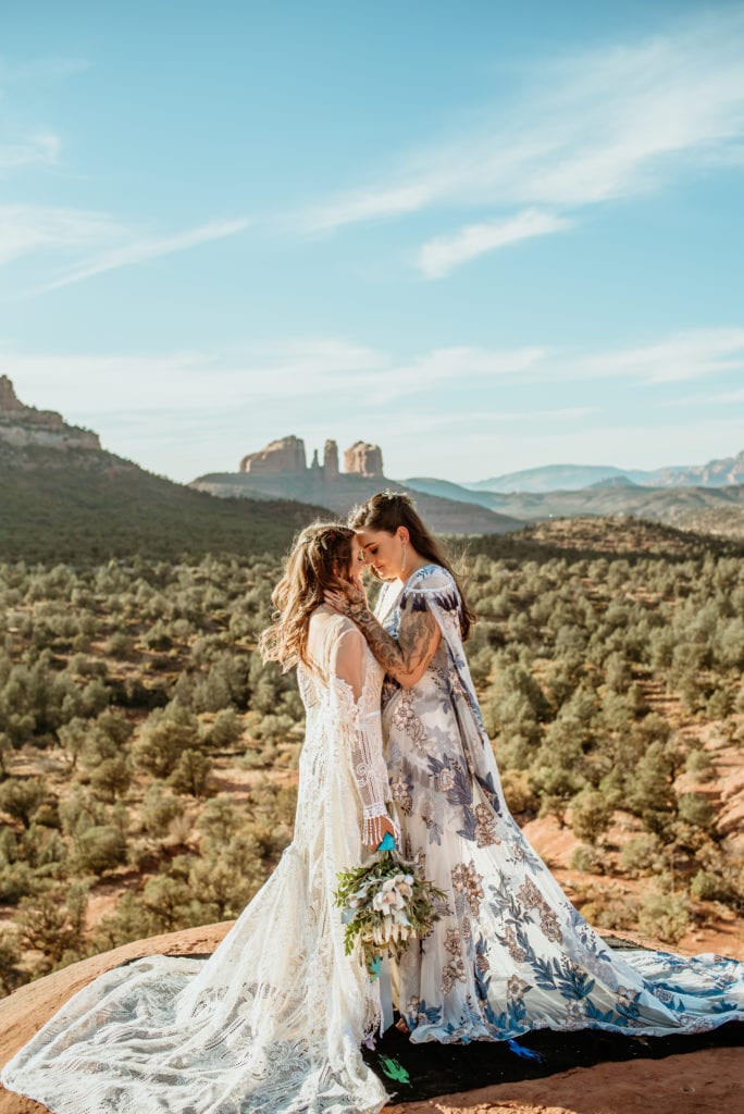 Romantic embrace with expansive views of Sedona in the background
