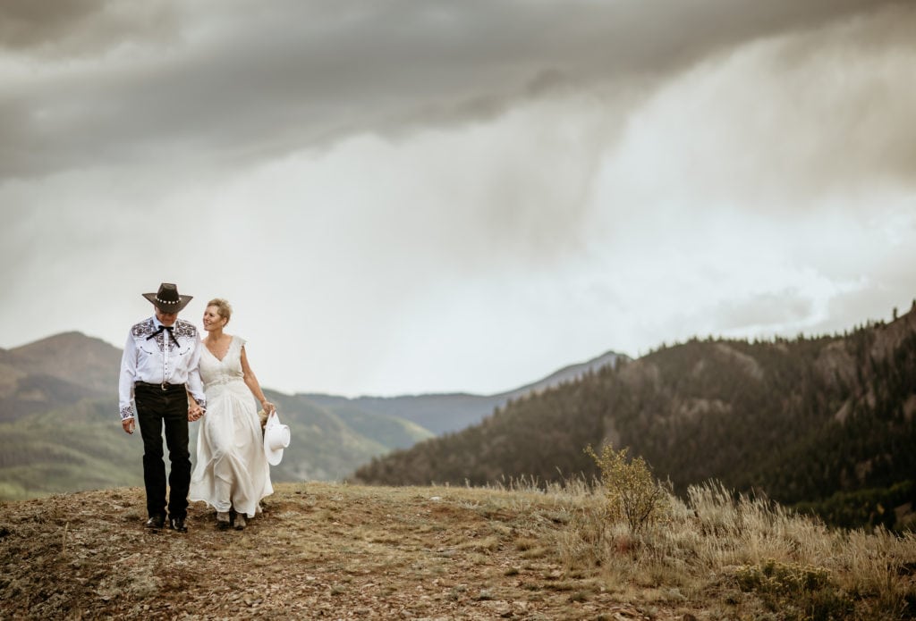 Wedding couple walking hand in hand during Colorado elopement